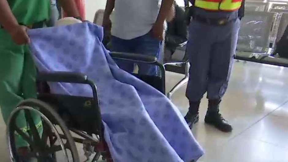 Medics escorting the little girl to the plane.