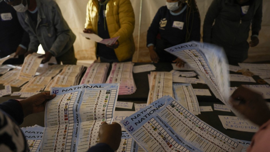 IEC) officials sort ballots during counting at Itereleng informal settlement polling station in Pretoria. Phill Magakoe/AFP