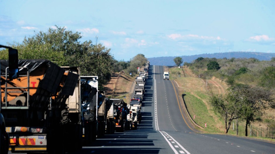 File: A line of trucks along the N4 highway. Leon Sadiki/Bloomberg via Getty Images