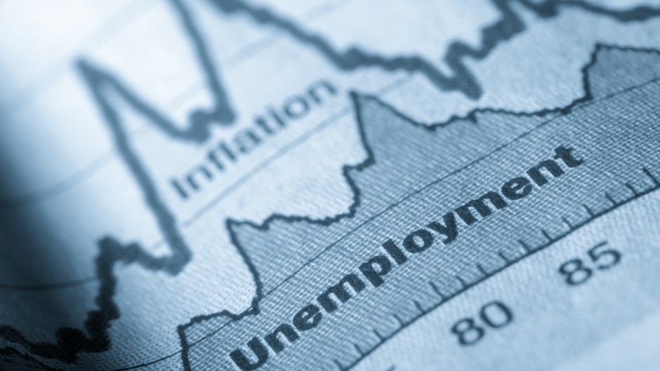 A folded sheet of paper with an unemployment graph on. Getty Images/JL Gutierrez