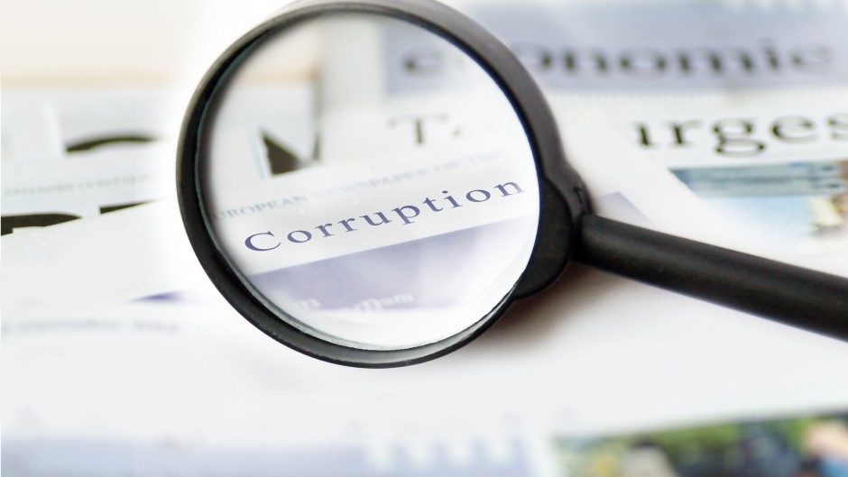 The word corruption seen on a piece of paper. Getty Images/TheaDesign