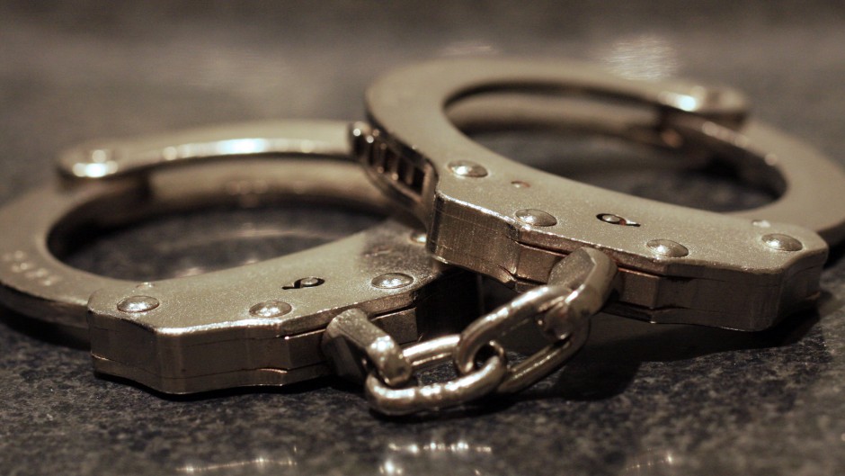 File: A pair of handcuffs on a table. Getty Images/James C Hooper