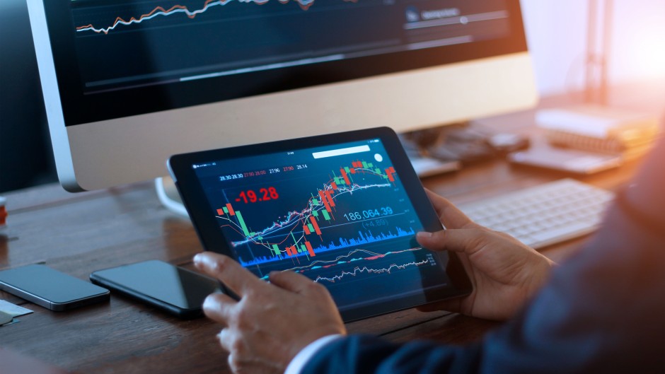 File: A businessman checking the stock market. Getty Images/ipopba