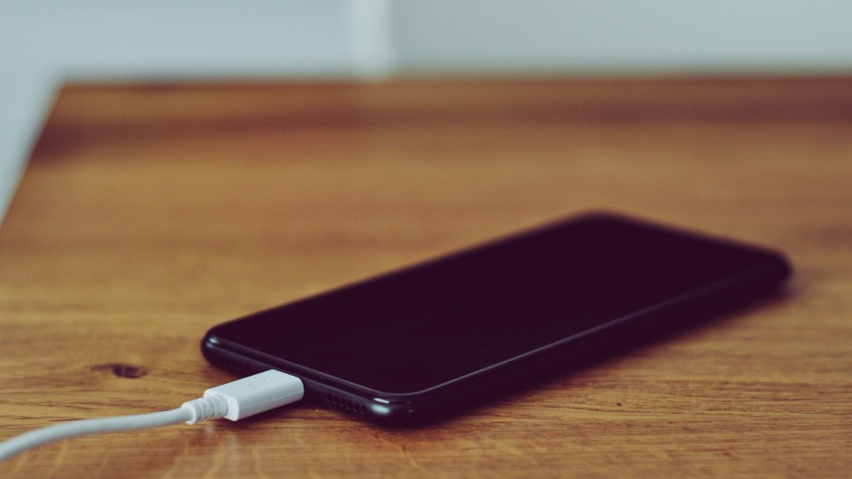 File: A cellphone and charger. Getty Images/Kinga Krzeminska