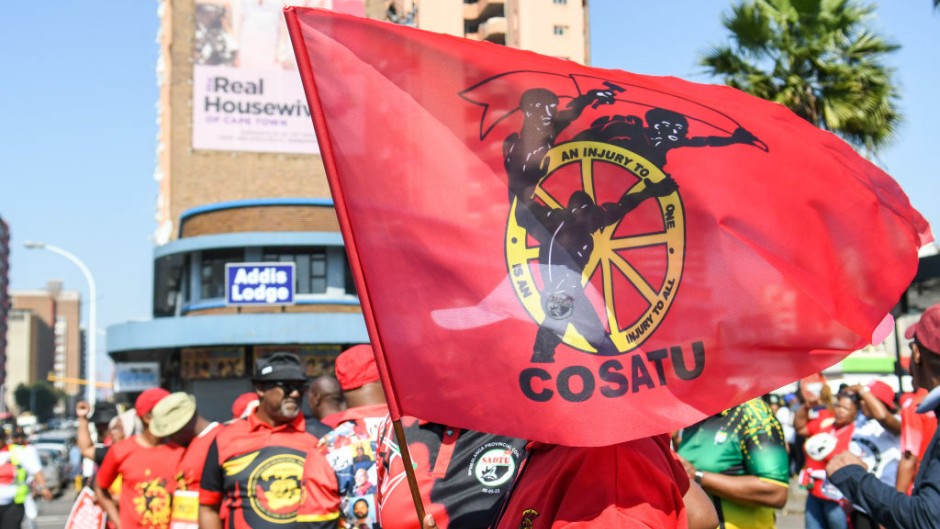 Members of Cosatu waving a flag. Darren Stewart/Gallo Images via Getty Images