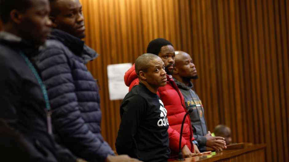 Five accused men in the Senzo Mayiwa murder trial stand in the dock at Pretoria High Court. Phill Magakoe/Gallo Images via Getty Images