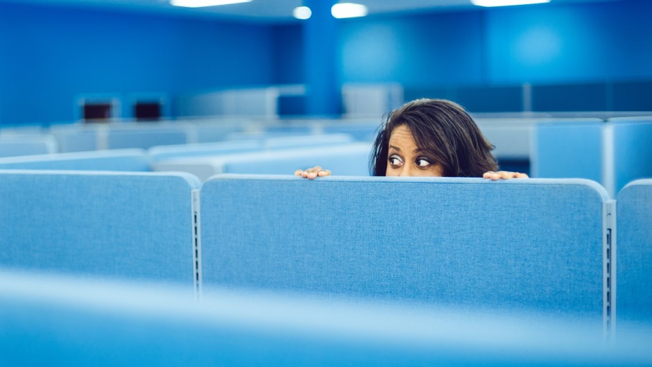 File: An office worker eavesdropping in cubicle room. Getty Images/ferrantraite