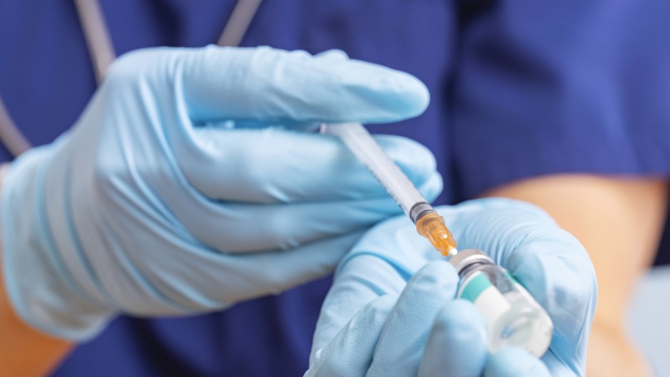 File: A healthcare worker fills a syringe with a vaccine. GettyImages/Andril Zorii