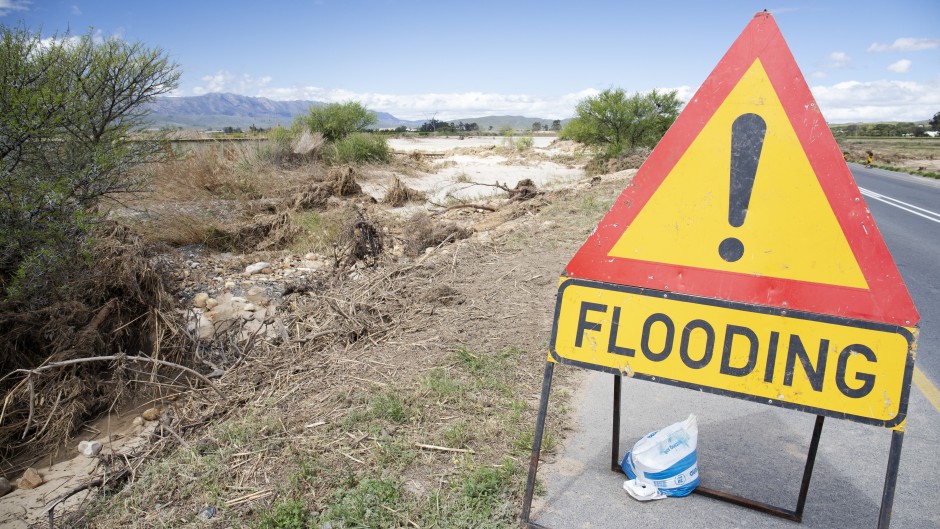 File: A flood warning sign. Dr Neil Overy/NOE/Science Photo Library via AFP