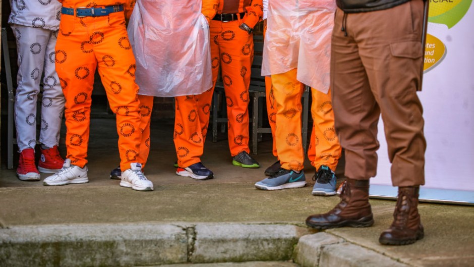 File: Prisoners standing next to a Correctional Services guard. Sharon Seretlo/Gallo Images via Getty Images