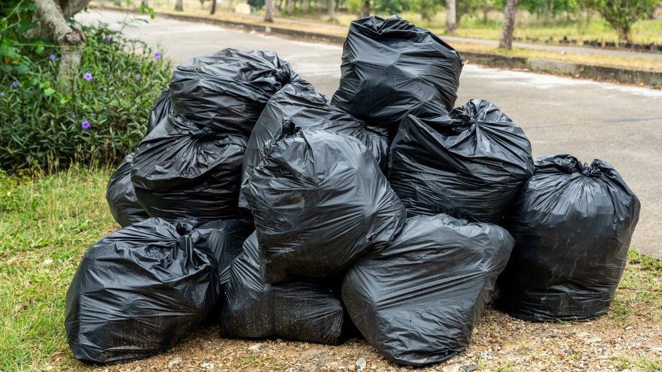 File: Black garbage bags on the pavement. GettyImages/Byjeng