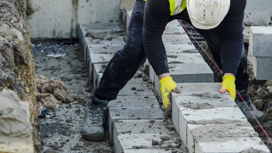 File: A bricklayer on a construction site. GettyImages/Iryna Melnyk