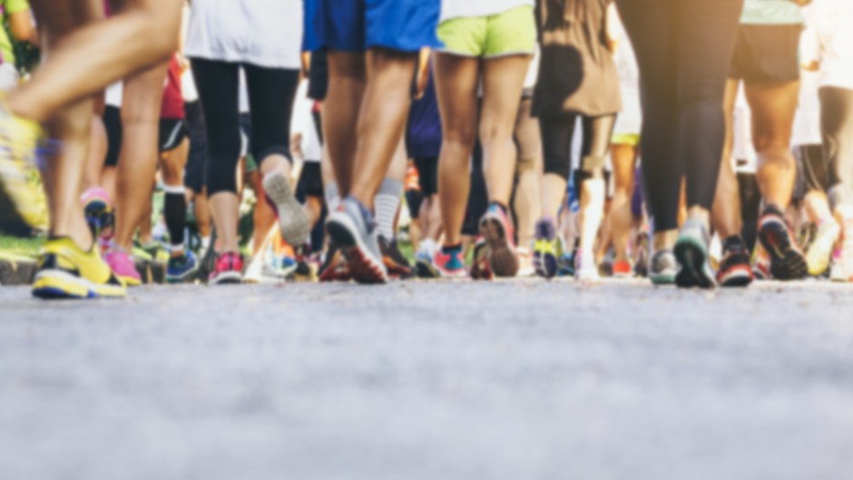 File: A crowd of people walking and running. GettyImages/VTT Studio