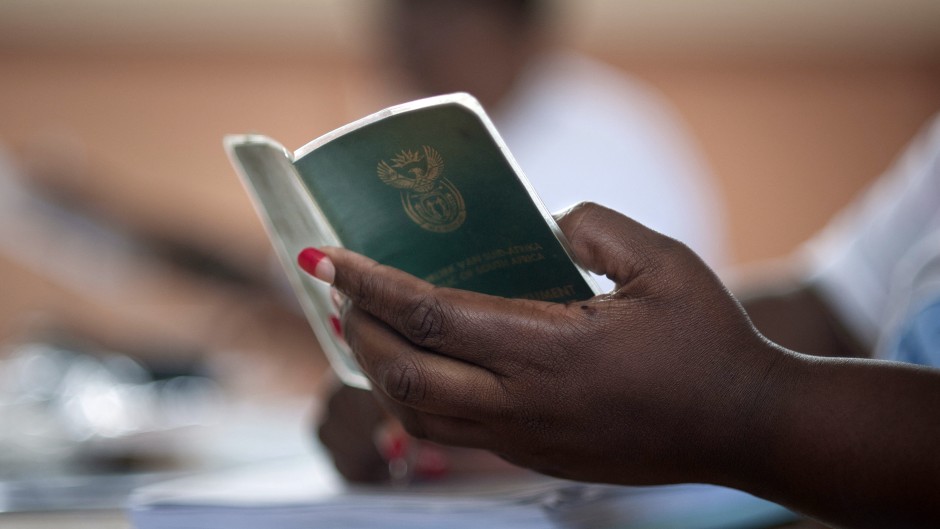 File: A woman holds an Identity book. 