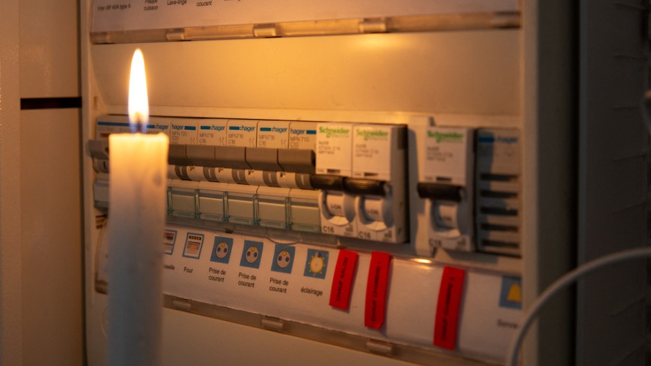 File: A candle next to an electricity meter. AFP/Valerie Dubois/Hans Lucas