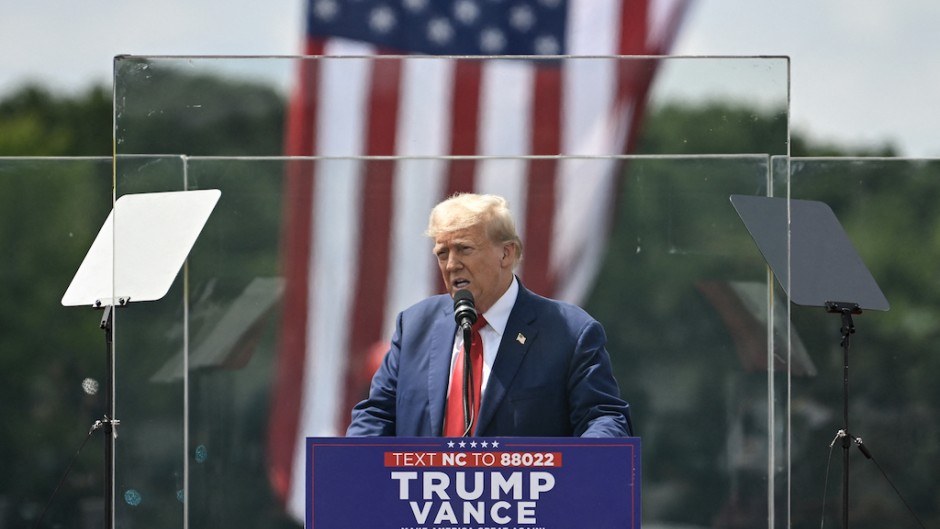  Former US President and Republican presidential candidate Donald Trump speaks behind bulletproof glass during a campaign rally. Peter Zay/AFP