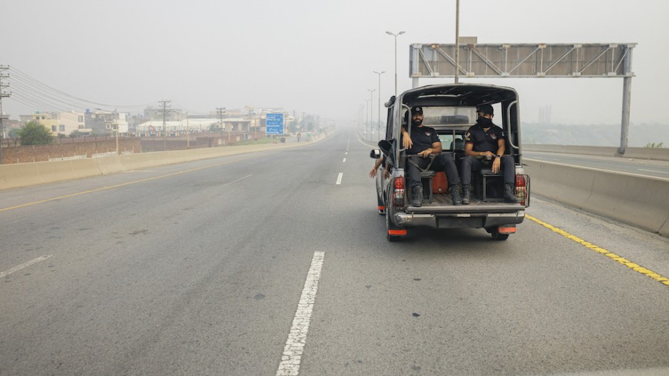 Police officers in a car on a highway in Lahore. Thomas Imo/Photothek Media Lab/dpa Picture-Alliance via AFP