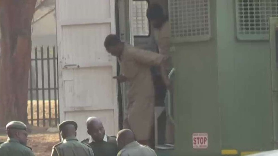 Zimbabwe activists coming out of a police vehicle