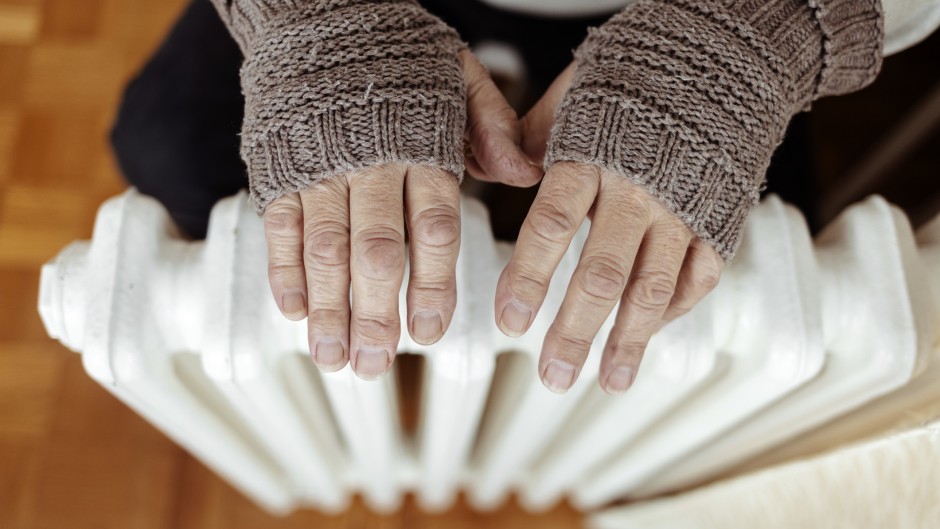 File: A man heats his hands over a heater. GettyImages/Jelena Stanojkovic