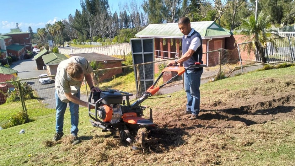 Emerging farmers with machinery