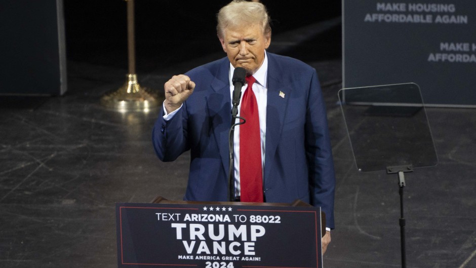 Former US President and Republican presidential candidate Donald Trump clenches his fist as he leaves after speaking during a campaign event. AFP/Rebecca Noble