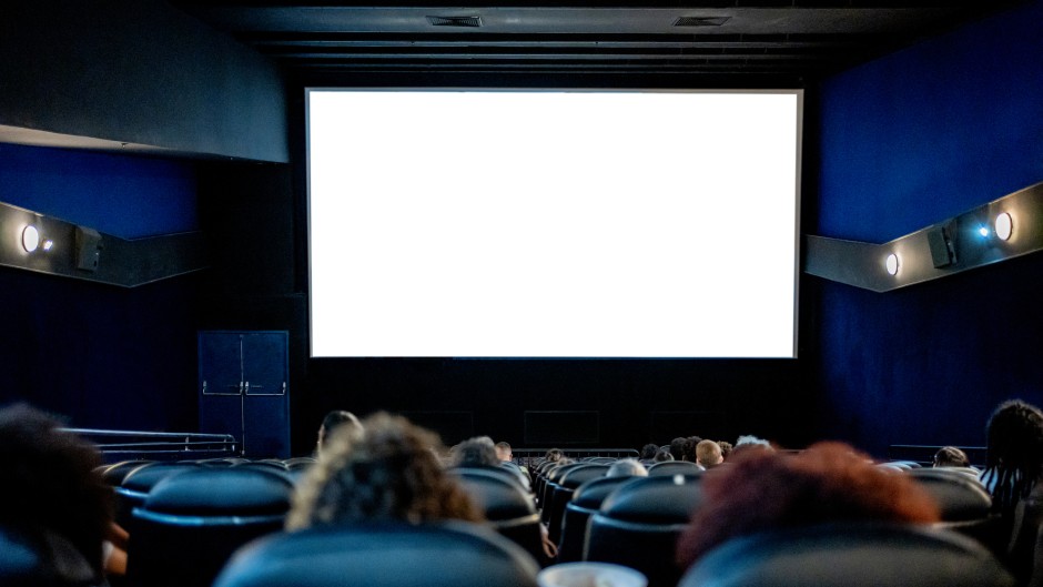 File: People watching a movie at the cinema. GettyImages/Drs Producoes