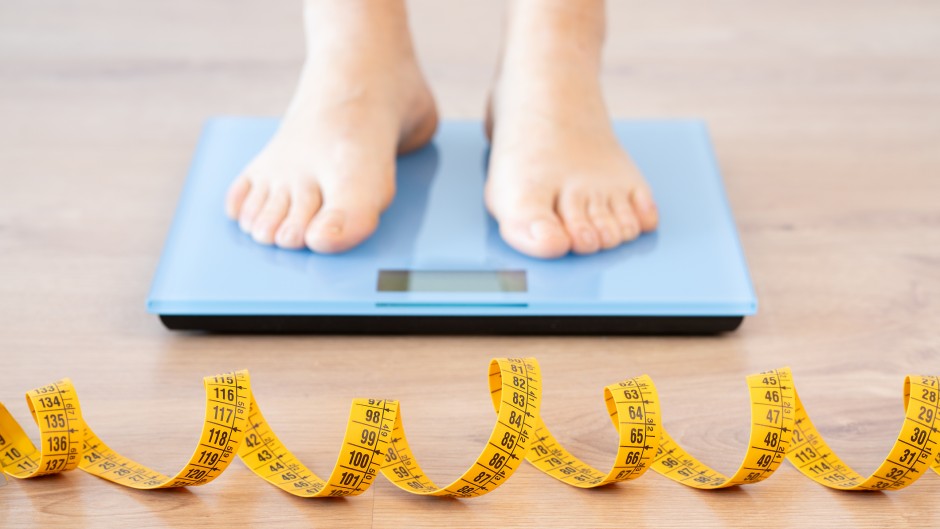 File: A person standing on a scale. Weight loss. GettyImages/Cunaplus_M.Faba