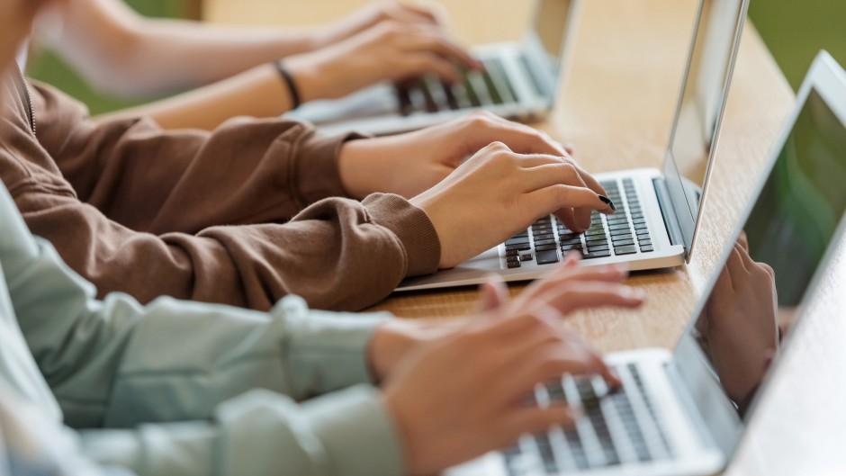 File: Children working on laptops. GettyImages/isuzek