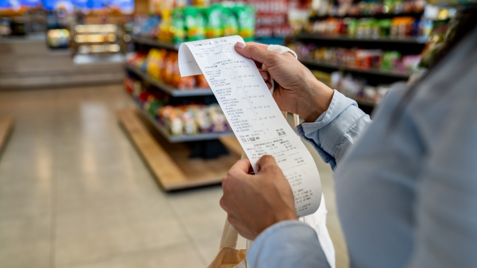 File: A shopper checking her receipt. GettyImages/Hispanolistic