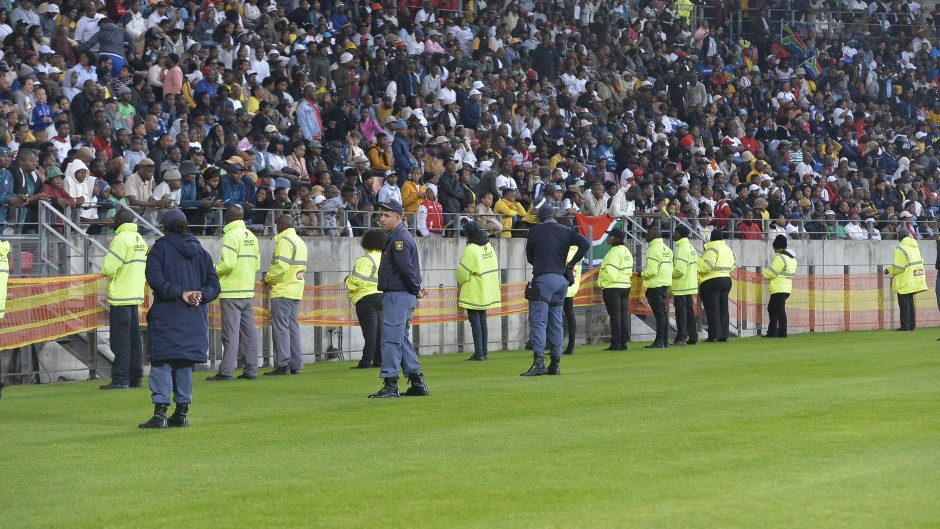 Unruly fans invaded the pitch during the first half of the game. BackpagePix/Deryck Foster