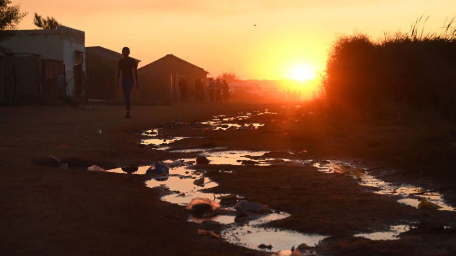 File: Puddles of sewage water on the side of a dirt road. Leon Sadiki/Bloomberg via Getty Images