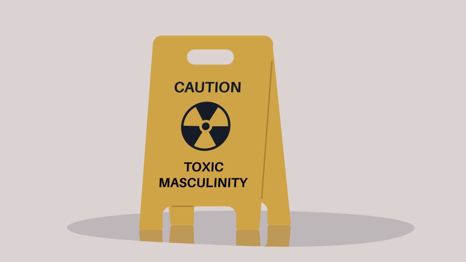 A yellow floor sign warning about toxic masculinity. GettyImages/nadia_bormotova