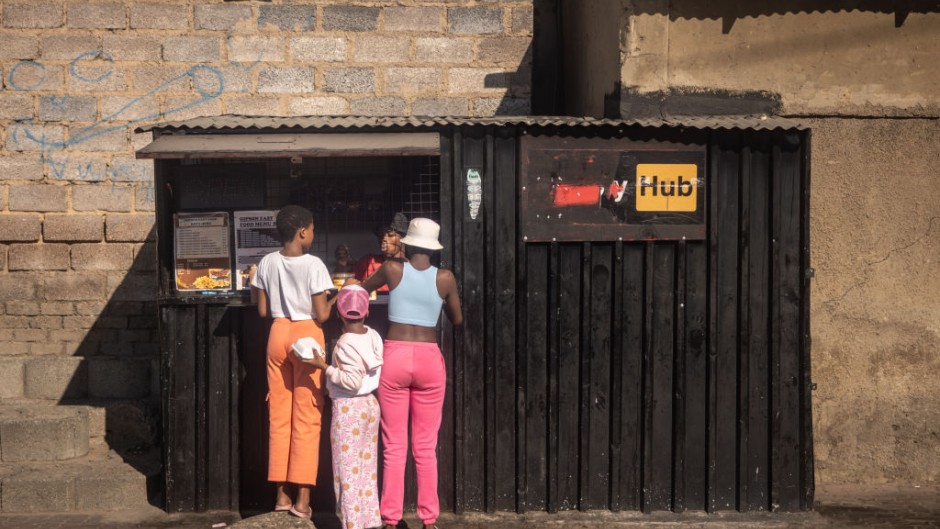 Girls shop at a tuck shop in Alexandra. Chris McGrath/Getty Images