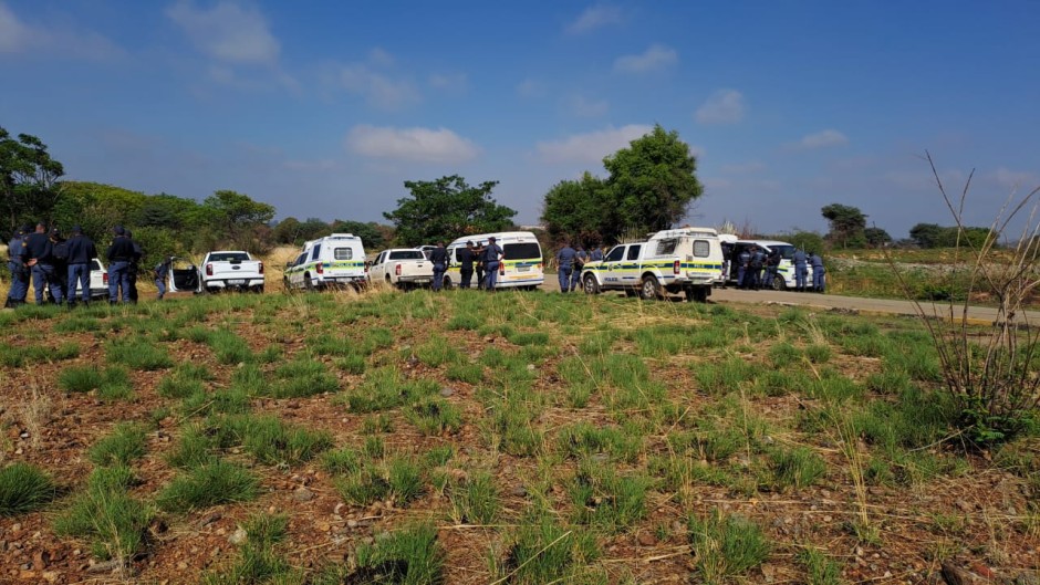 Police officers on the scene where zama zamas remain underground. eNCA/Bafedile Moerane