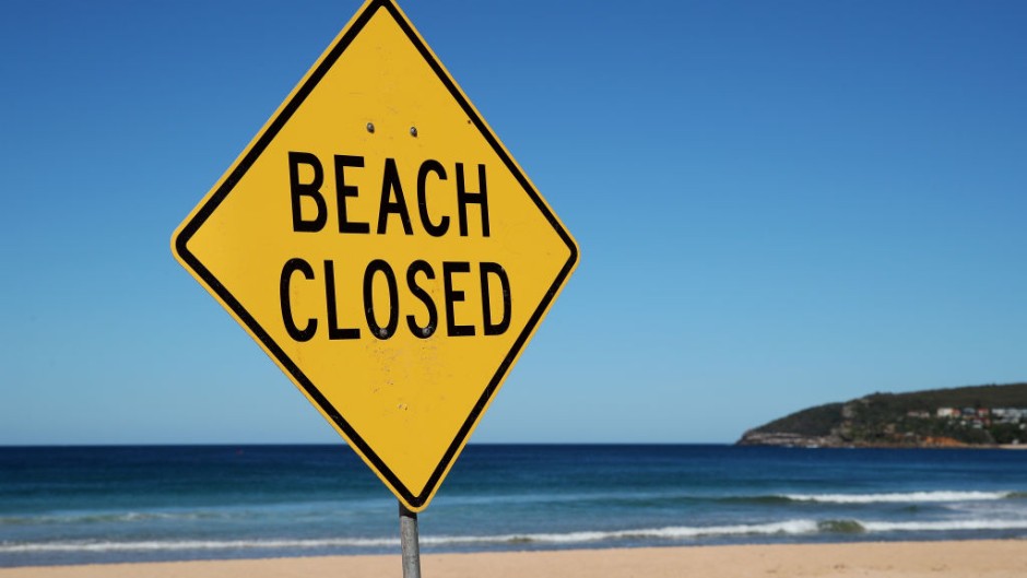 File: A Beach Closed sign. GettyImages/Cameron Spencer