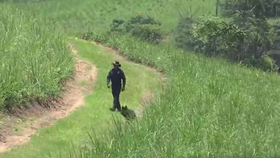 Police officers search for a toddler's body in Othongathi, KZN