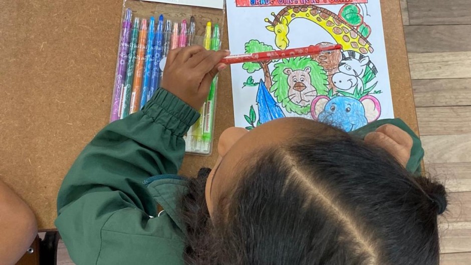 Back to school: A grade one pupil sits on her desk as schools reopen