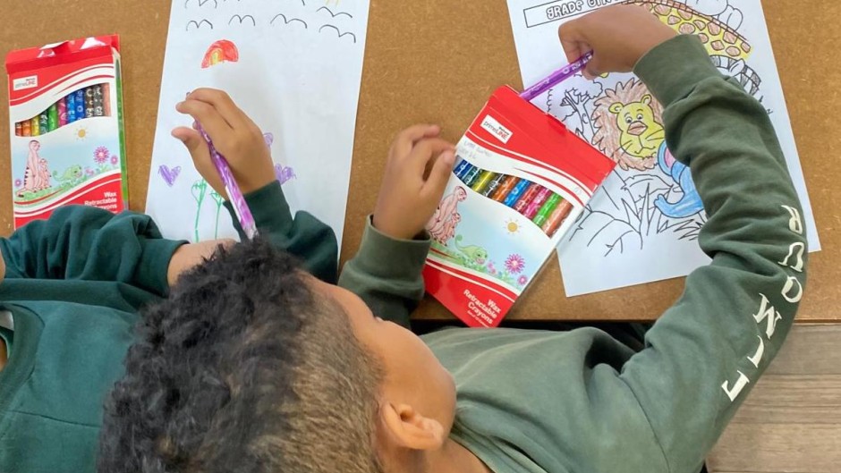 Back to school: A grade one pupil sits on his desk as schools reopen