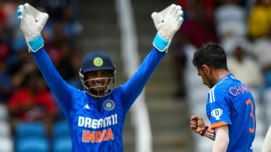 That's out: Yuzvendra Chahal (right) and Ishan Kishan celebrate the dismissal of Brandon King