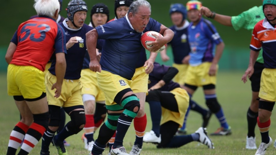 Channeling the spirit of Japan star Kotaro Matsushima, a player darts through a gap in an over-70s match in Utsunomiya