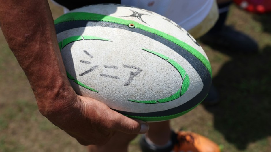 The word 'senior' is inscribed in Japanese on a ball used at an Over-70s training session in Kamakura