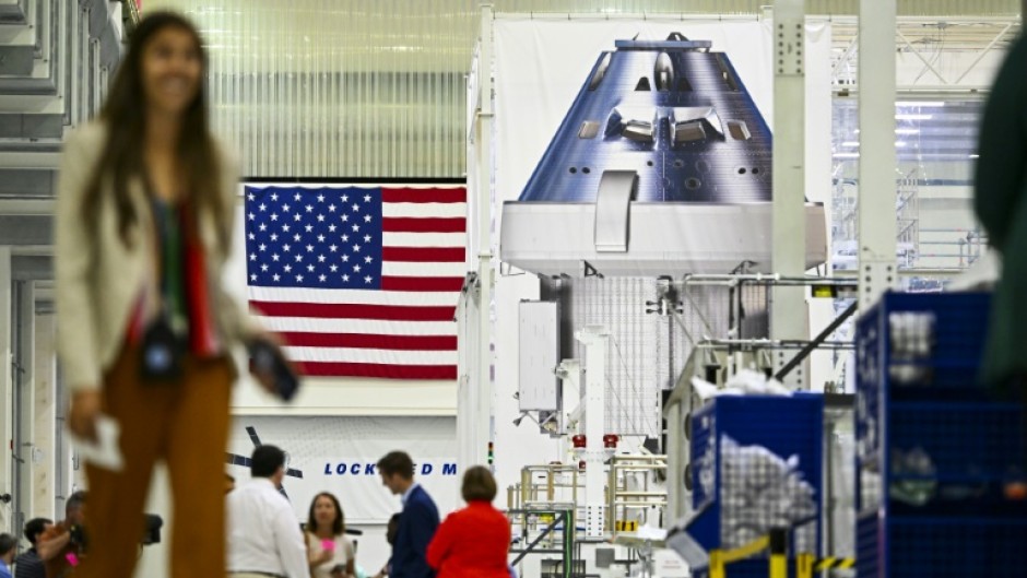 Officials and media personnel are seen inside the Operations and Checkout Building (O&C) at the Kennedy Space Center in Cape Canaveral, Florida