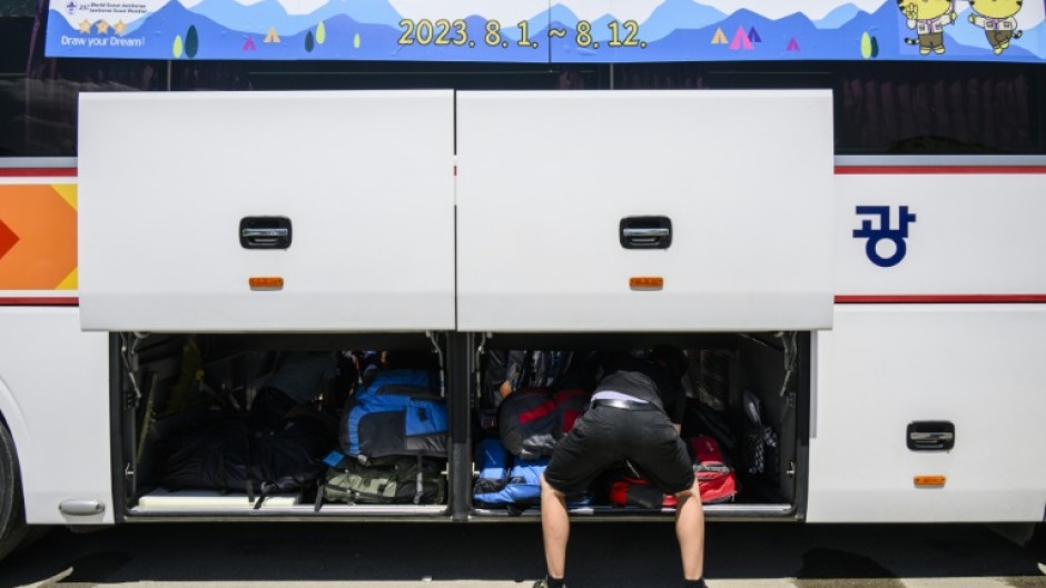 Scouts prepare to leave the  World Scout Jamboree camspite in South Korea's North Jeolla province, which has been plagued by problems and is being evacuated as a typhoon approaches