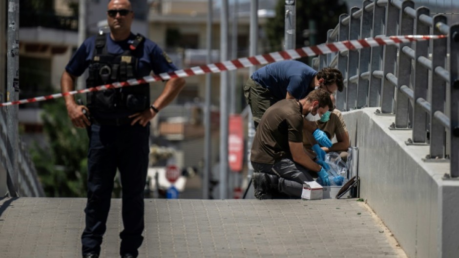 Greek police search for evidence after the fatal stabbing of a fan which saw the Champions League qualifier between AEK Athens and Dinamo Zagreb postponed