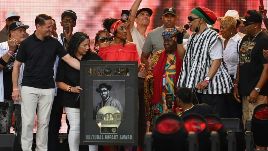 US rapper DJ Kool Herc (R) recieves the Cultural Impact Award during the Hip Hop 50 Live concert, which marked five decades of the genre