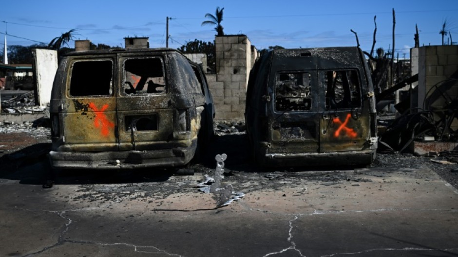 Spray-painted Xs marked vehicles that lay in the street -- a sign to firefighters they have been checked for victims