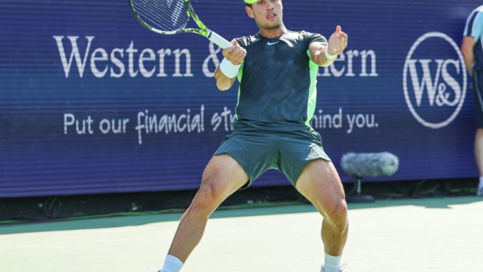 Carlos Alcaraz scrambles for a forehand in his loss to Novak Djokovic in the final of the ATP Cincinnati Open