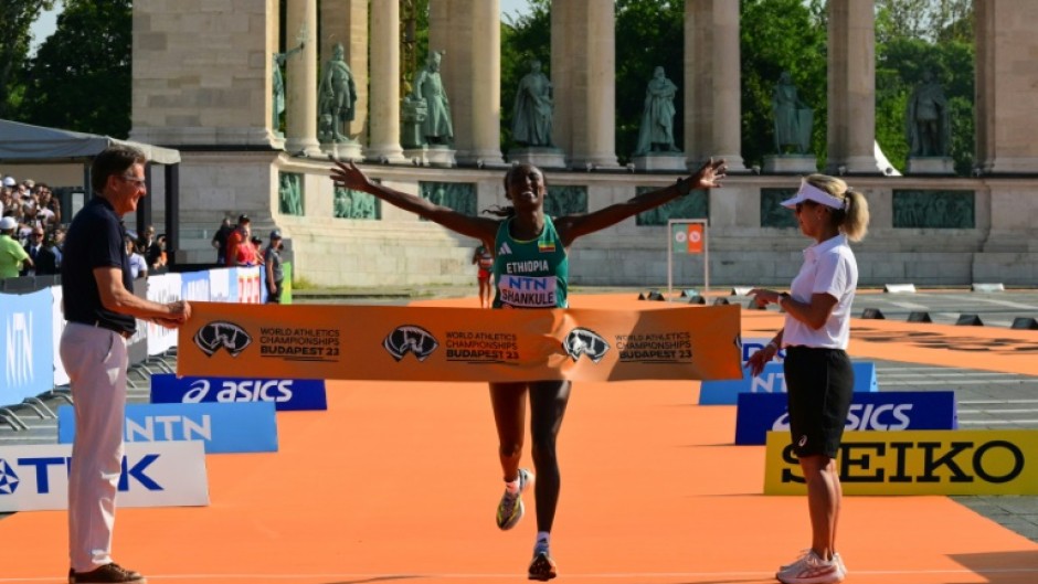 Ethiopia's Amane Beriso Shankule celebrates as she crosses the finish line to win the women's marathon