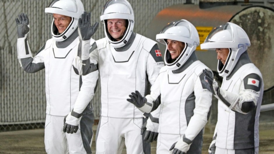 (From L) Konstantin Borisov, Andreas Mogensen, Jasmin Moghbeli and Satoshi Furukawa,  wearing SpaceX spacesuits, wave before they depart for the ISS