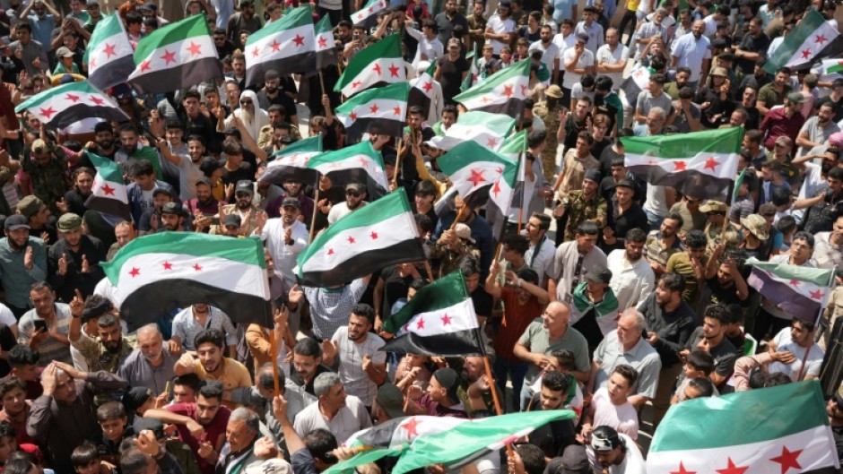 Syrians in the rebel-held northern city of Azaz demonstrate in solidarity with the protesters in the government-ruled south